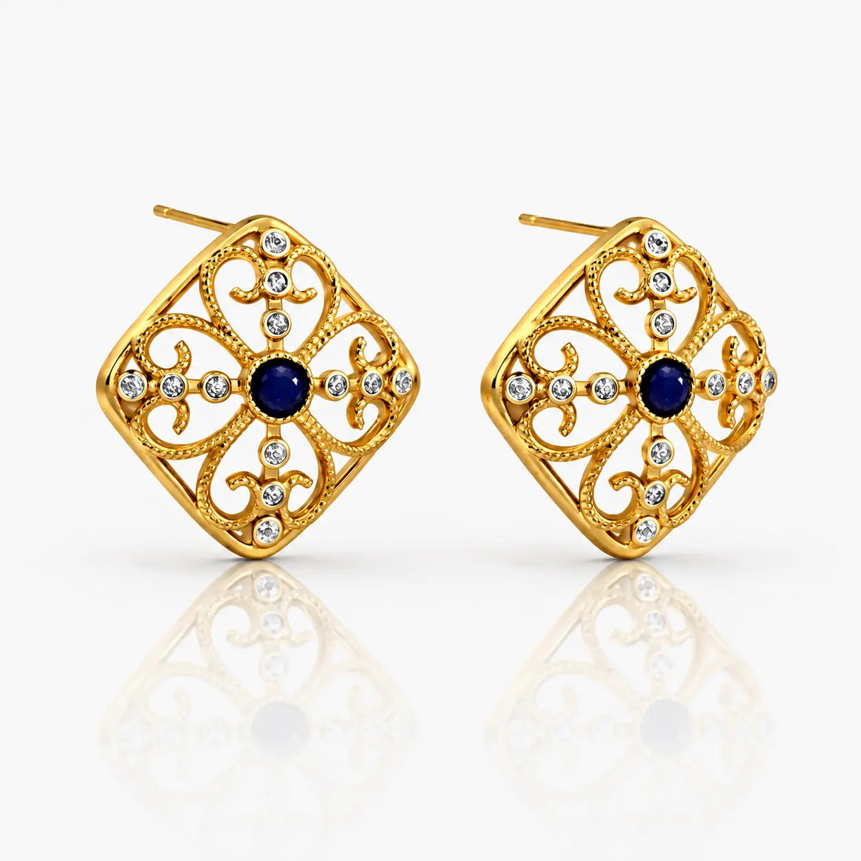 Gold earrings with blue gemstones on a white background