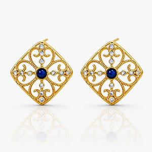 Gold earrings with blue gemstones on a white background