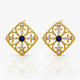 Gold earrings with blue gemstones on a white background