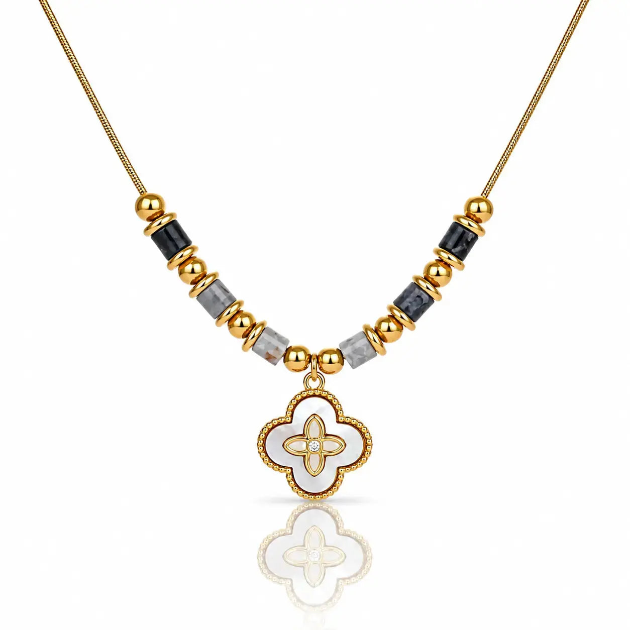 A gold-plated necklace featuring a central white enamel quatrefoil pendant with a gold border, flanked by alternating gold and black faceted beads on a white background.