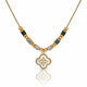 A gold-plated necklace featuring a central white enamel quatrefoil pendant with a gold border, flanked by alternating gold and black faceted beads on a white background.