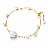 A delicate gold chain anklet featuring a large baroque pearl and several smaller white freshwater pearls, displayed on a clean white background.