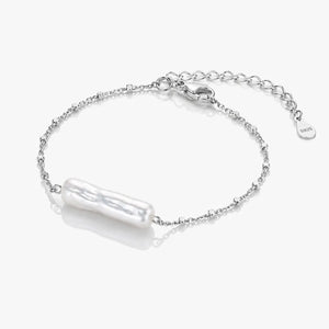 Silver bracelet with a pearl-like charm on a white background