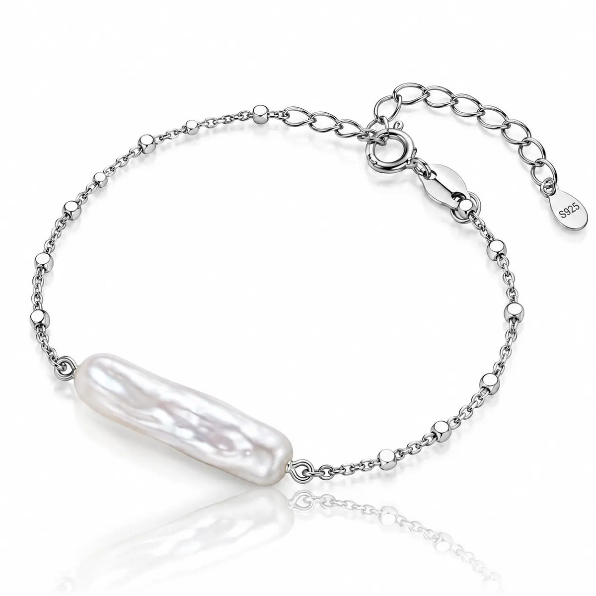 A silver chain bracelet featuring a large, lustrous baroque pearl pendant, displayed on a clean white background with a soft reflection.