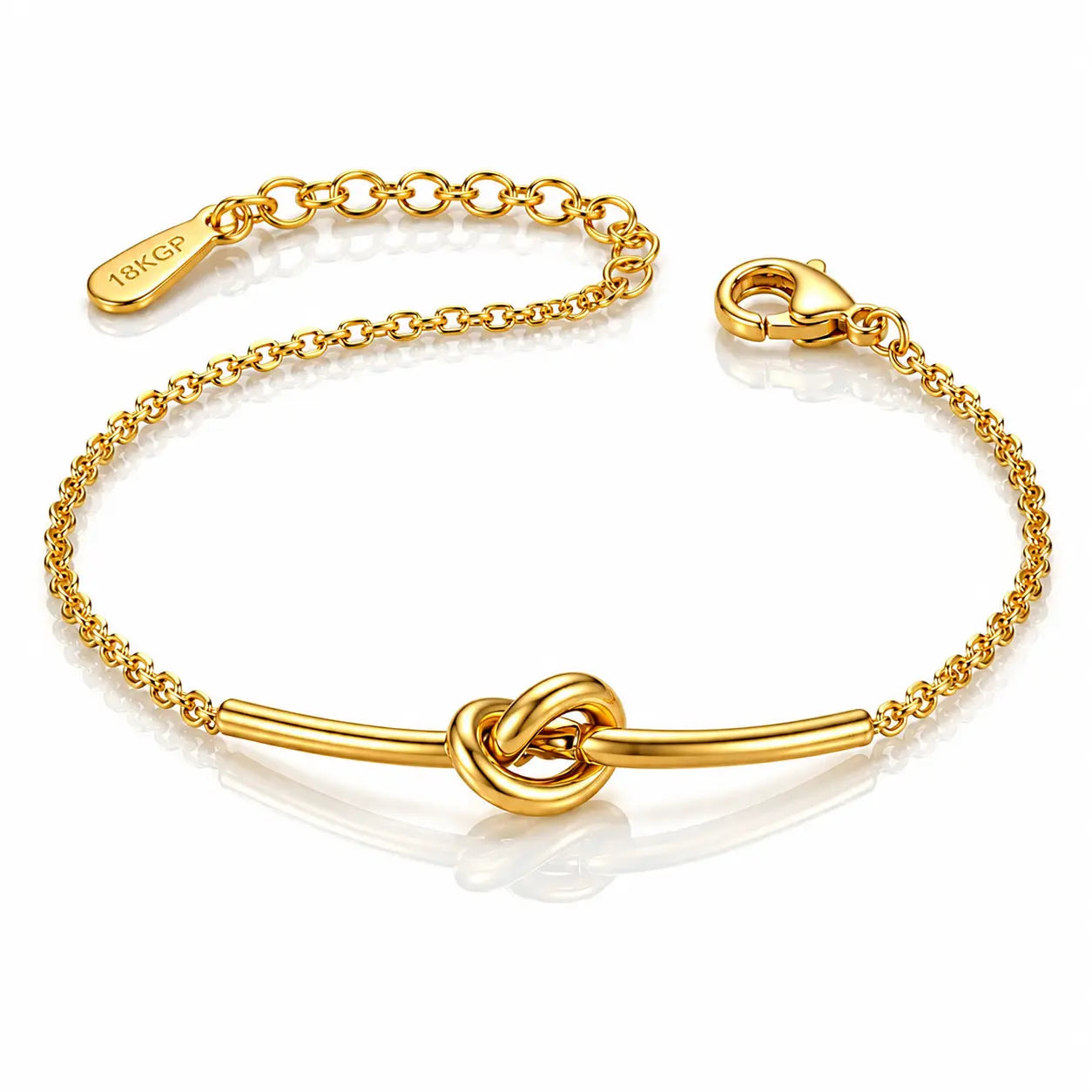 A gold chain bracelet with a central bar and knot design, featuring a lobster clasp and an adjustable chain extender engraved with the brand name 'TOKYO'.