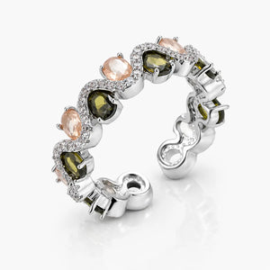 Silver ring with green and pink gemstones on a white background