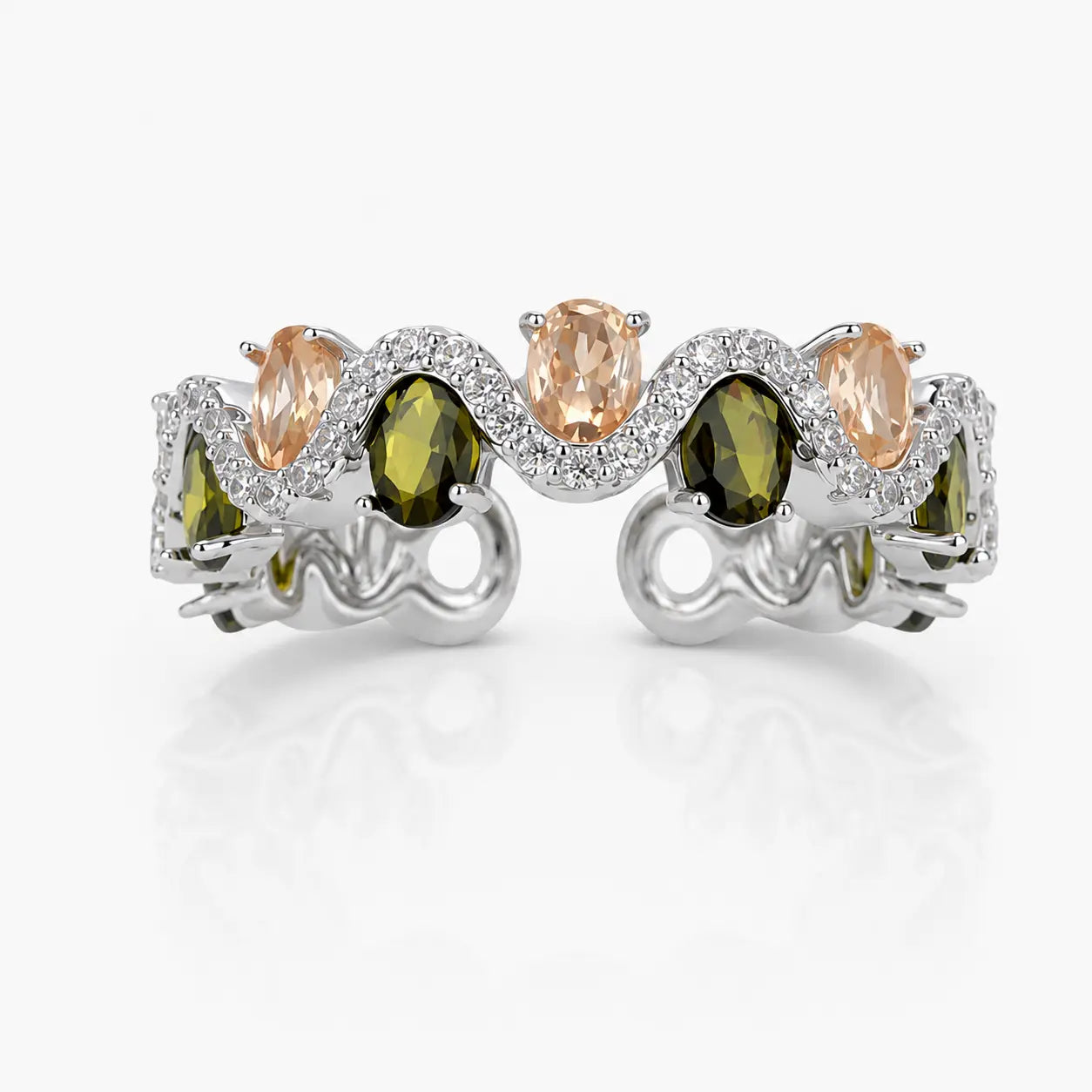 Silver ring with green and peach-colored gemstones on a white background