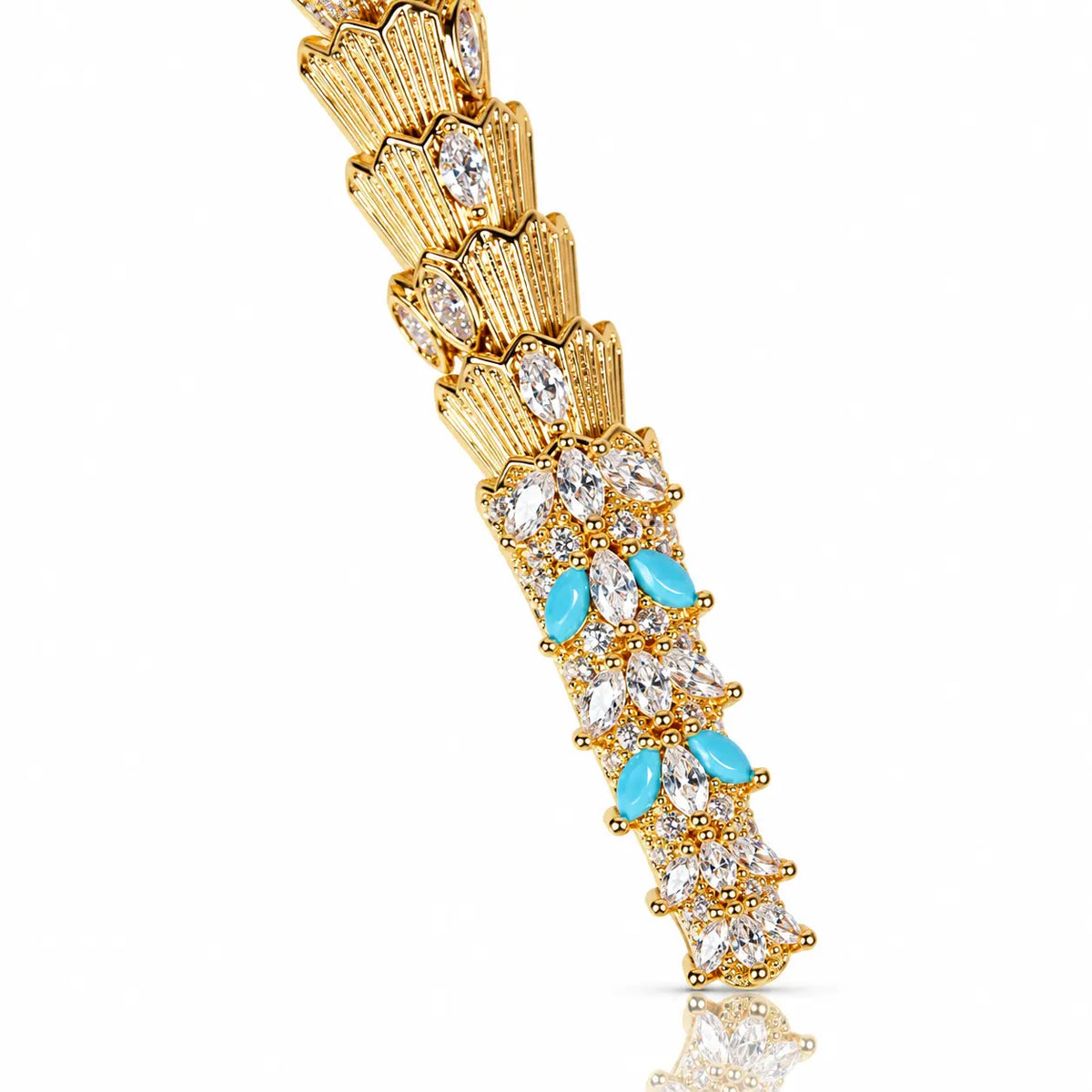 A gold-plated link bracelet with clear marquise-cut crystals and turquoise blue marquise-cut accents, shown on a clean white background with a soft reflection.