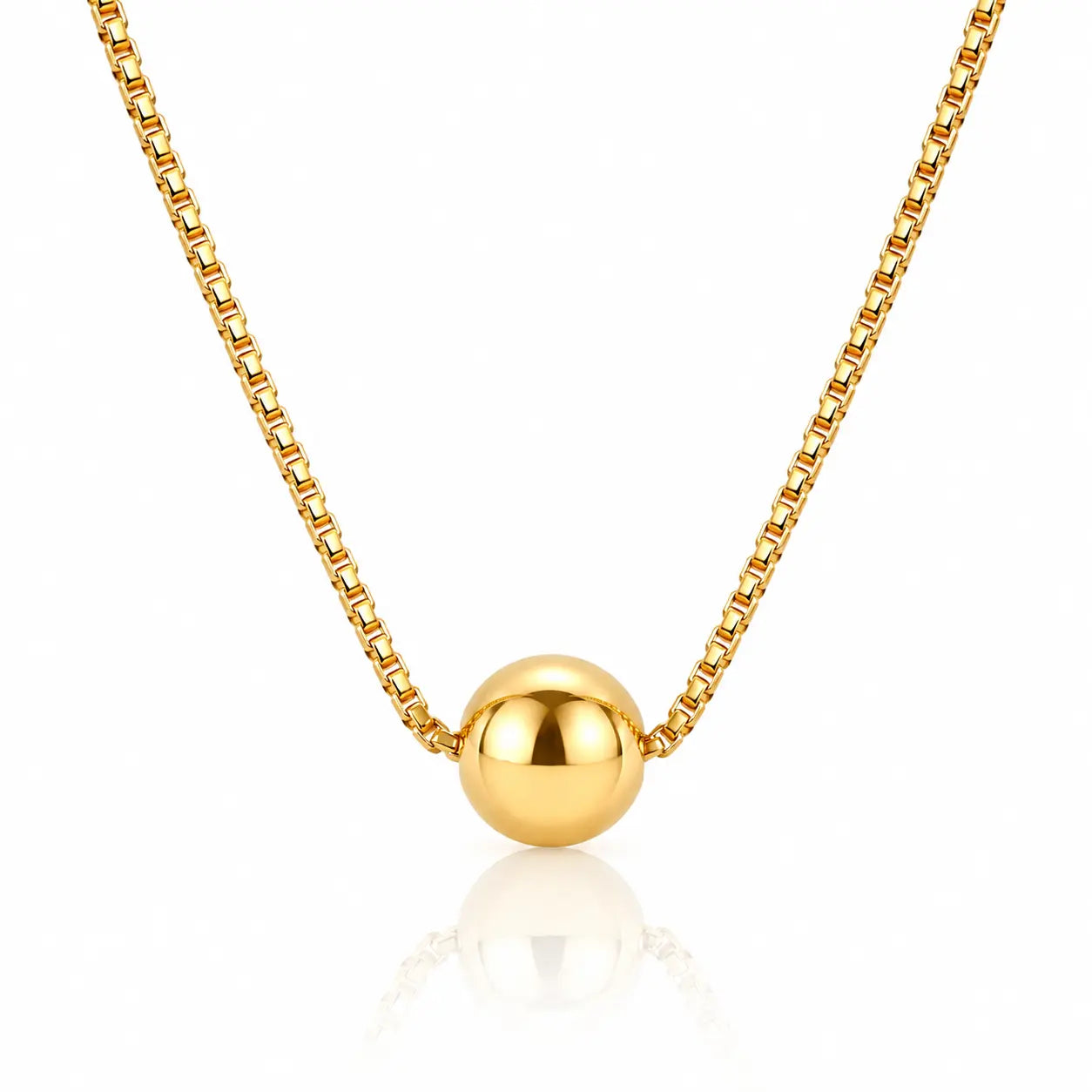 A gold box chain necklace with a polished spherical bead pendant, displayed against a clean white background with a soft reflection below.