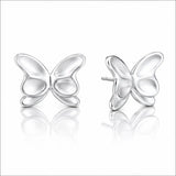 A pair of silver butterfly stud earrings shown on a clean white background with soft reflections below. One earring is facing forward and the other is angled to show the side profile and post.