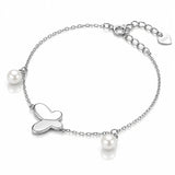 A silver chain bracelet featuring a central heart-shaped charm, two small white pearls, and a heart-shaped brand tag engraved with 'SOL' on a clean white background.