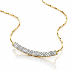 A pair of gold huggie hoop earrings set with clear pavé gemstones on a clean white background with a soft reflection below.