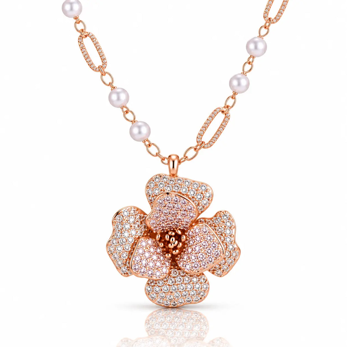 Rose gold floral pendant necklace with a flower-shaped centerpiece paved with clear stones and a chain featuring white pearls and textured rose gold links, shown on a white background with a soft reflection.