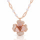 Rose gold floral pendant necklace with a flower-shaped centerpiece paved with clear stones and a chain featuring white pearls and textured rose gold links, shown on a white background with a soft reflection.