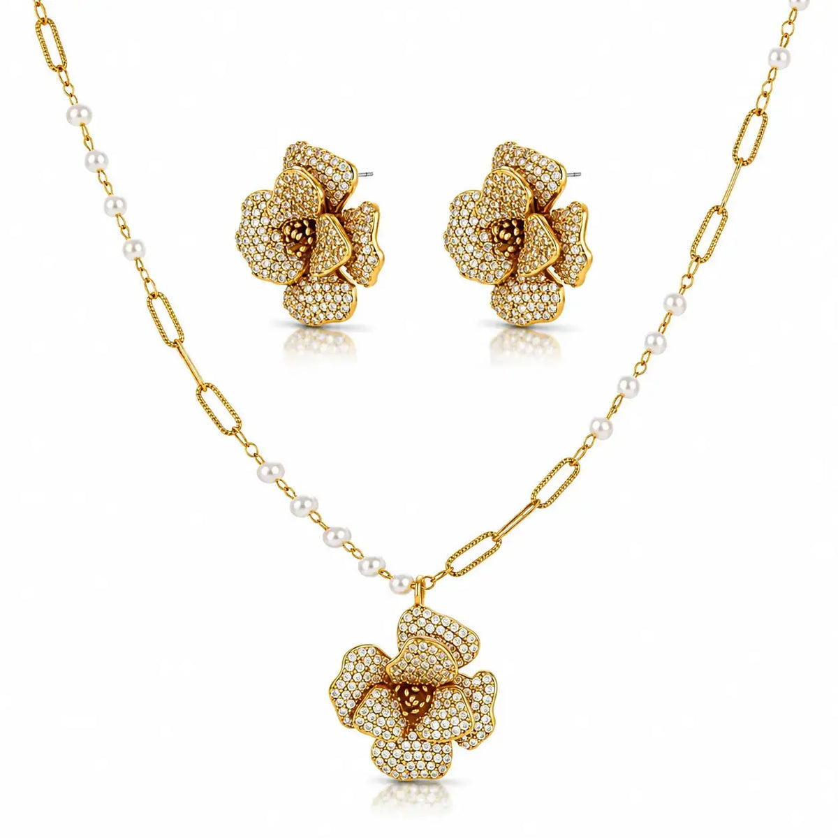 Gold-tone floral jewelry set with a pendant necklace, matching stud earrings, and a chain featuring small white pearls, shown on a clean white background.