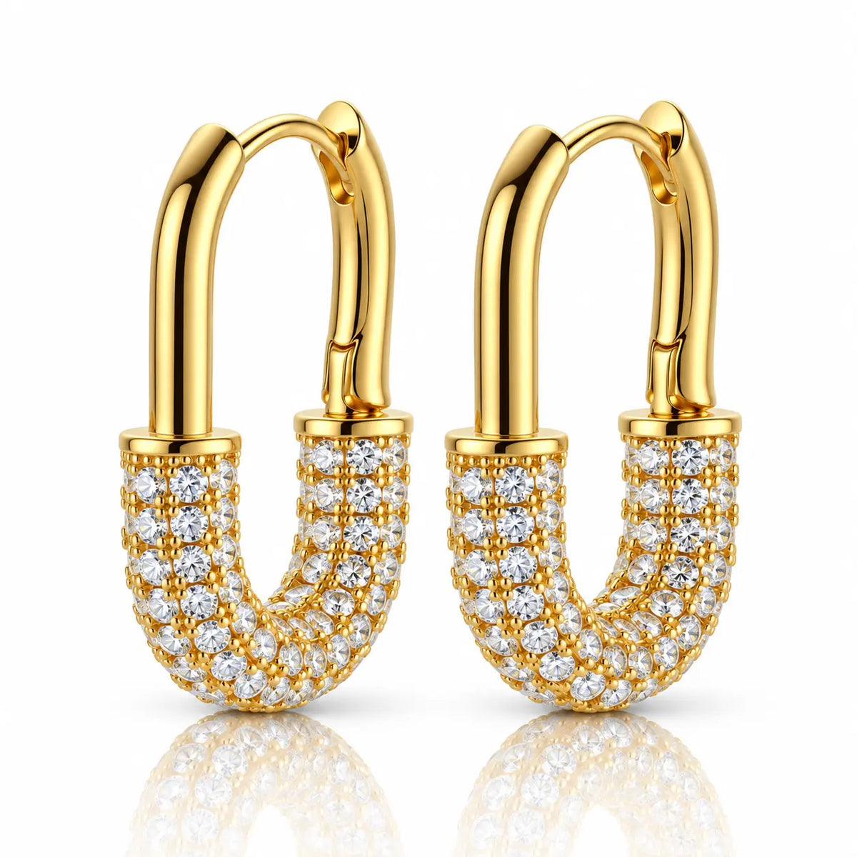 A pair of gold hoop earrings with curved, shield-like U-shaped fronts paved with clear cubic zirconia stones, shown on a white background with a soft reflection below.