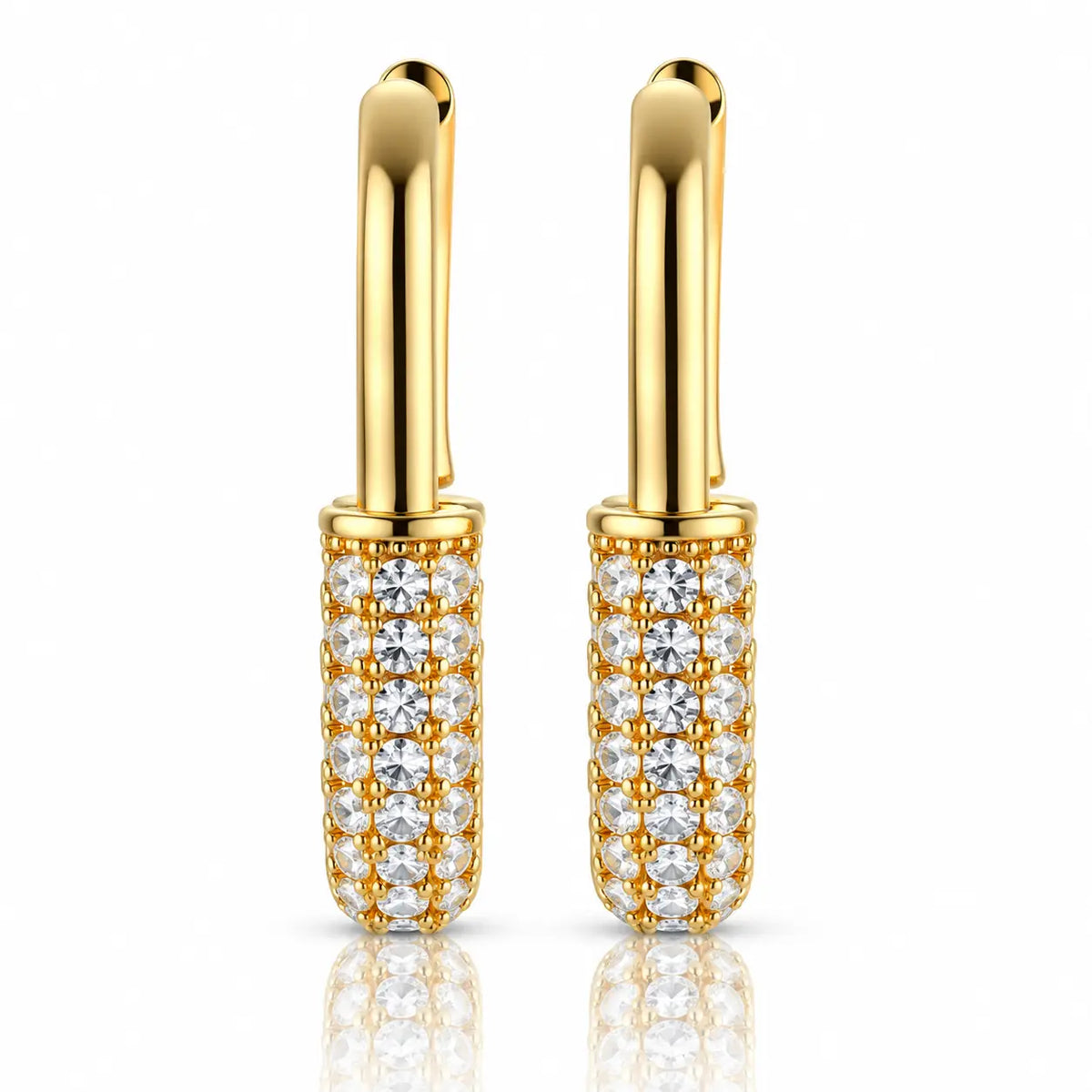 A pair of gold hoop earrings with cylindrical pavé-set clear gemstone bodies, shown on a clean white background with a soft reflection below.