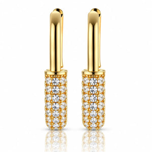 A pair of gold hoop earrings with cylindrical pavé-set clear gemstone bodies, shown on a clean white background with a soft reflection below.