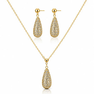 Gold jewelry set featuring a teardrop-shaped pendant necklace and matching drop earrings, both adorned with pavé-set clear stones on a white background.