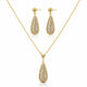 Gold jewelry set featuring a teardrop-shaped pendant necklace and matching drop earrings, both adorned with pavé-set clear stones on a white background.