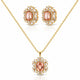 Gold jewelry set featuring a pendant necklace and matching stud earrings with oval peach-pink center stones surrounded by clear crystals on a white background.