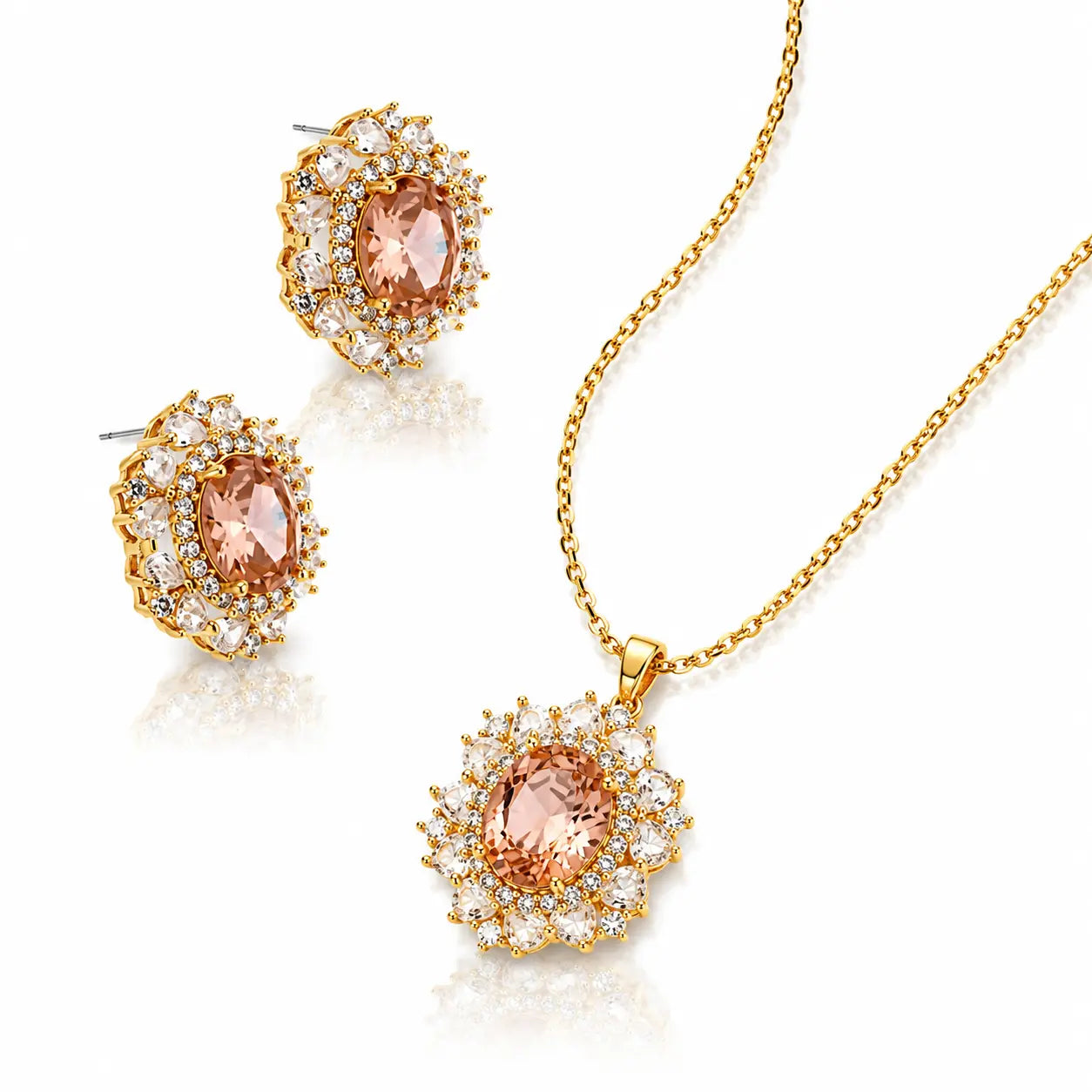 Gold jewelry set featuring a pendant necklace and matching stud earrings, each with an oval peach-colored center stone surrounded by clear cubic zirconia halos on a white background.