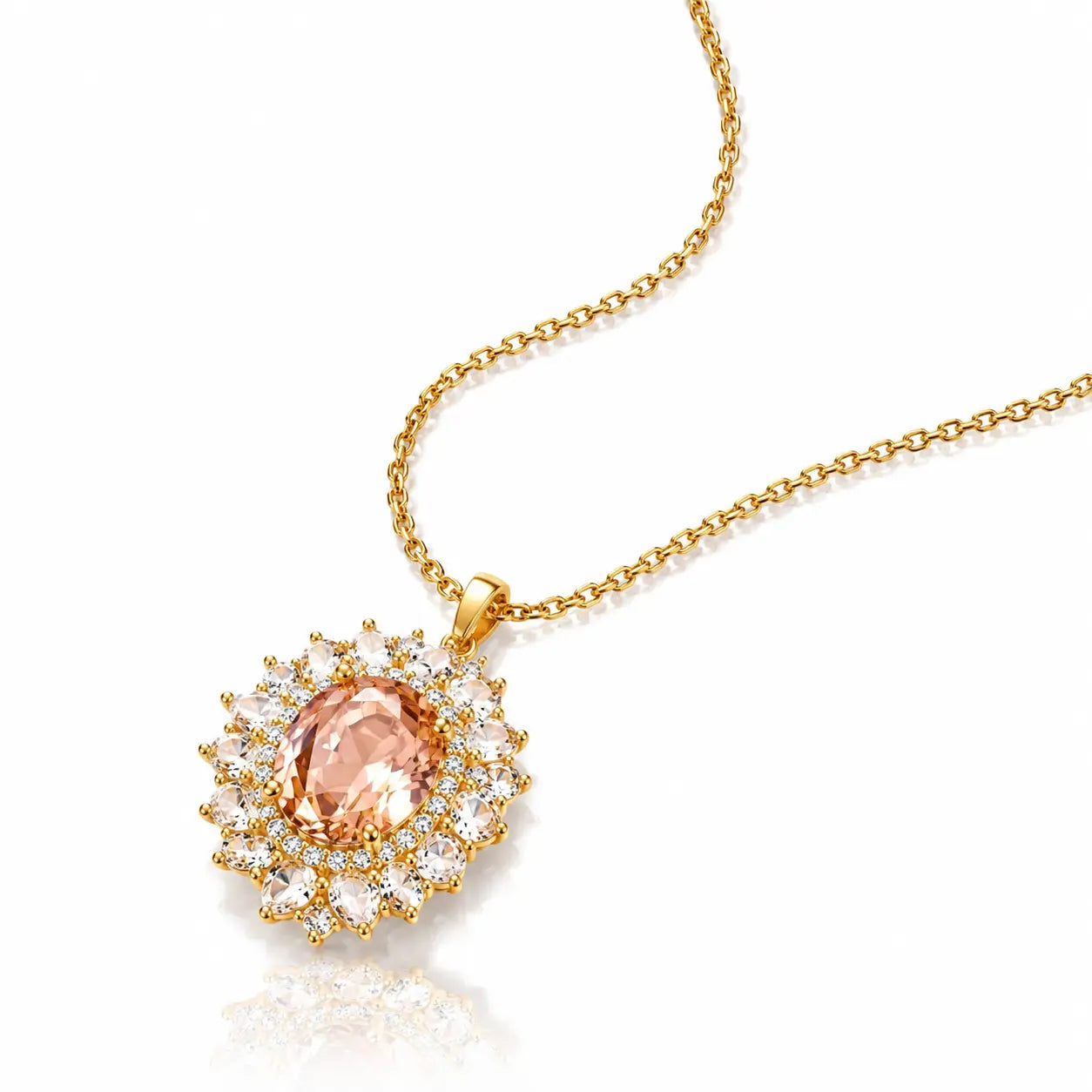 A gold chain necklace with a sunburst pendant featuring a central peach-colored gemstone surrounded by clear accent stones, shown on a white background with a soft reflection.