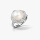 Silver ring with large round pearl center and halo of small clear gemstones on white background