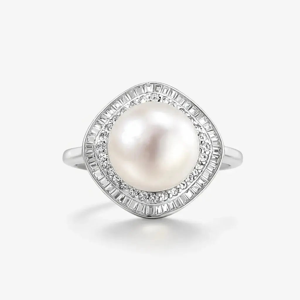 Silver ring with a large round pearl center and baguette-cut diamond halo on white background