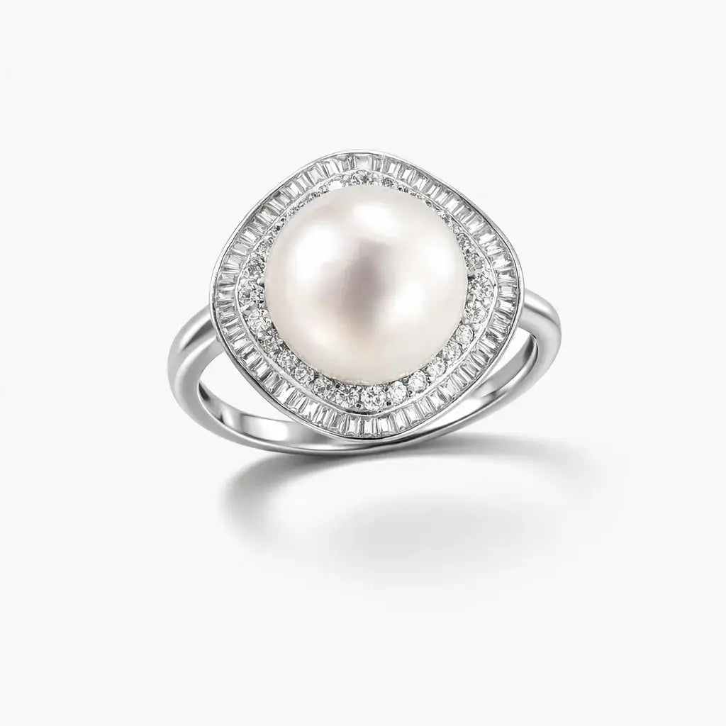 Silver ring with large round pearl center and halo of clear baguette and round gemstones