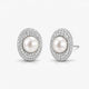 Elegant oval pearl stud earrings with double halo of sparkling pave stones on white background.