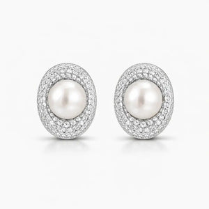 Elegant pearl stud earrings with sparkling crystal halo on white background