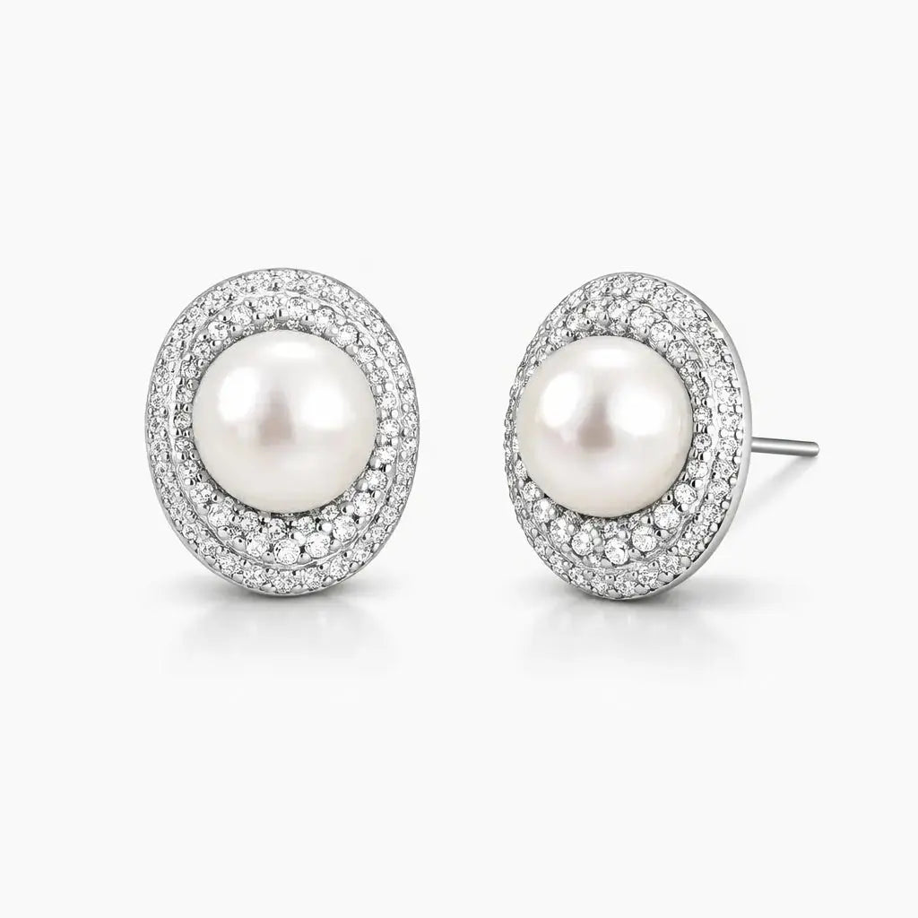 White pearl stud earrings with pavé crystal halo on silver setting, elegant jewelry