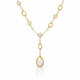 A gold and pearl necklace featuring a Y-shaped design with a large teardrop-shaped pearl pendant in a gold frame, set against a clean white background with a subtle reflection.