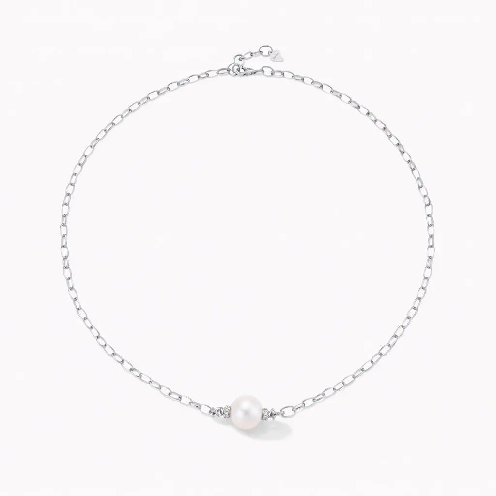 Silver chain necklace with single round pearl centerpiece on white background