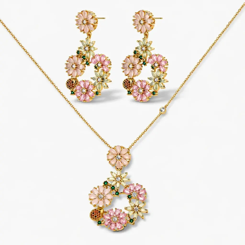 Gold plated floral necklace and earring set with pink, white, and green cubic zirconia.