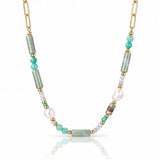 A gold chain necklace featuring green amazonite cylindrical beads, turquoise and white beads, and a large white baroque pearl, displayed on a clean white background with a soft reflection.