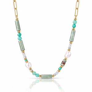 A gold chain necklace featuring green amazonite cylindrical beads, turquoise and white beads, and a large white baroque pearl, displayed on a clean white background with a soft reflection.