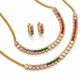 Gold jewelry set featuring a necklace, matching earrings, and a bracelet, each adorned with baguette-cut rainbow-colored stones and clear pavé accents on a white background.