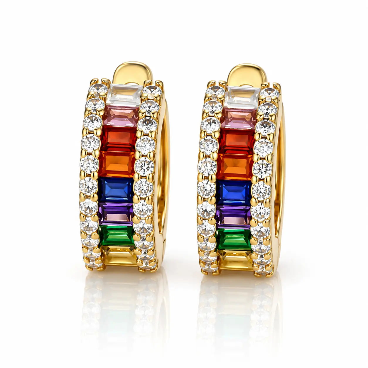 A pair of gold huggie hoop earrings featuring a vibrant rainbow channel set with baguette-cut gemstones and rows of clear round stones, shown on a reflective white background.