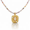 Gold pendant necklace with multicolored beads on a white background