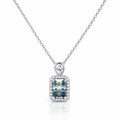 A silver-toned necklace with a rectangular iridescent gemstone pendant surrounded by a halo of small clear stones, suspended from a delicate silver chain on a white background.