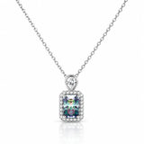 A silver-toned necklace with a rectangular iridescent gemstone pendant surrounded by a halo of small clear stones, suspended from a delicate silver chain on a white background.