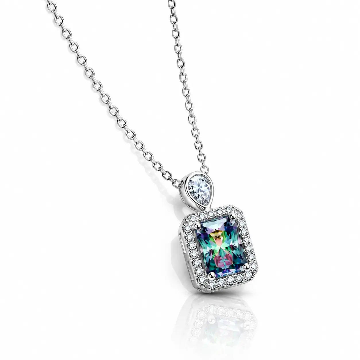 A silver chain necklace with a rectangular iridescent gemstone pendant surrounded by small clear stones, on a white background with a soft reflection.