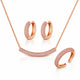 Rose gold jewelry set featuring a necklace with a pavé curved bar pendant, matching pavé hoop earrings, and a pavé open cuff ring, displayed on a clean white background.