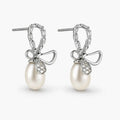 Pearl earrings with bow design on a white background