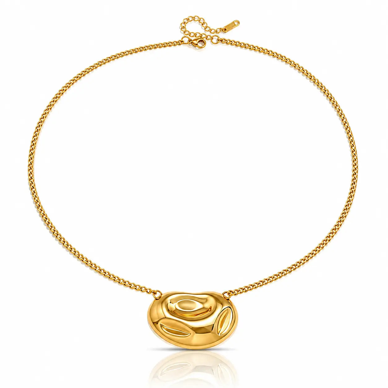 A gold chain necklace featuring a polished, organic-shaped oval pendant, displayed on a clean white background with a subtle reflection below.