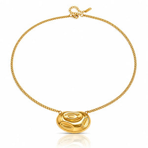 A gold chain necklace featuring a polished, organic-shaped oval pendant, displayed on a clean white background with a subtle reflection below.