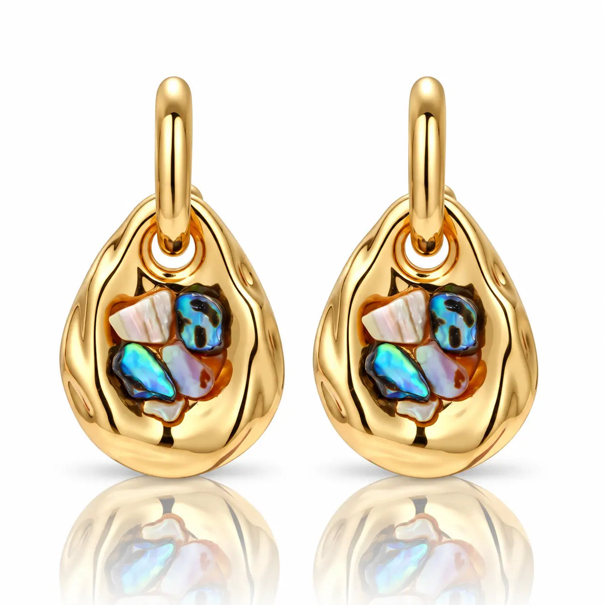 A pair of gold teardrop-shaped earrings with a textured outer setting and an interior cluster of iridescent shell pieces in blue, white, and orange, shown on a white background with a soft reflection below.