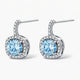 Silver drop earrings with round blue gemstones and pavé clear crystals on white background